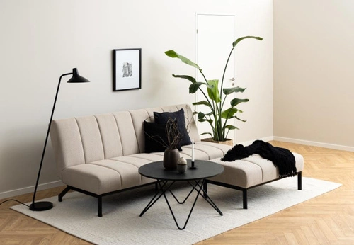 Podnóżek tapicerowany Caix beżowy Actona do salonu i sypialni, nowoczesny prostokątny na czarnych nogach